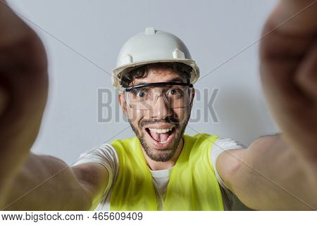 Smiling Male Engineer Taking A Selfie Looking At Camera. Funny Builder Engineer Taking A Selfie Isol