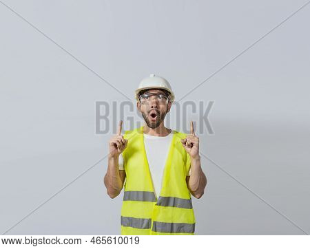 Surprised Young Architect Pointing Up, Amazed Engineer Pointing At An Advertisement. Concept Of An E