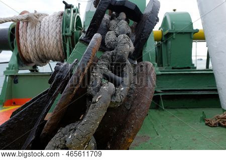 Anchor Chain From The Anchor Winch On The Foredeck. Dirty And Rusty Chain Maritime Background