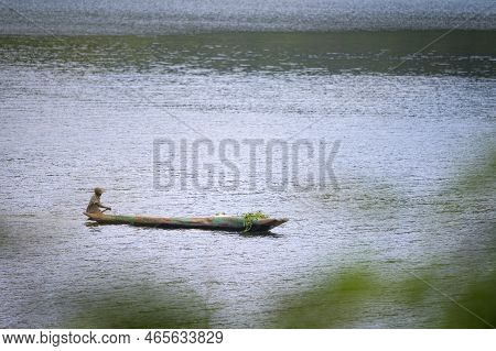 Kabale, Uganda - June 12, 2022: Man In A Dugout Canoe On Lake Bunyonyi (uganda), Sunny Day In Summer