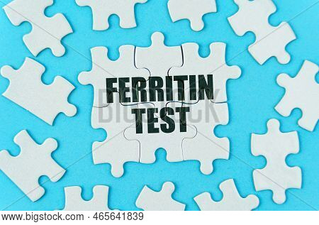 Medical Concept. On A Blue Background Are White Puzzles With The Inscription - Ferritin Test