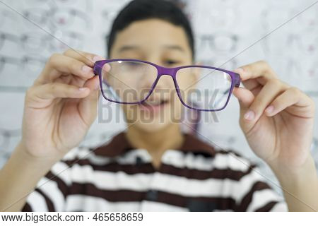 Smart Young Buy Student In Striped Polo T-shirt Happy Trying Out, Testing, And Choosing New Eyeglass