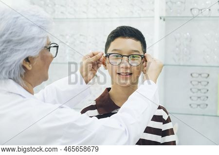 Smart Young Buy Student In Striped Polo T-shirt Happy Trying Out, Testing, And Choosing New Eyeglass