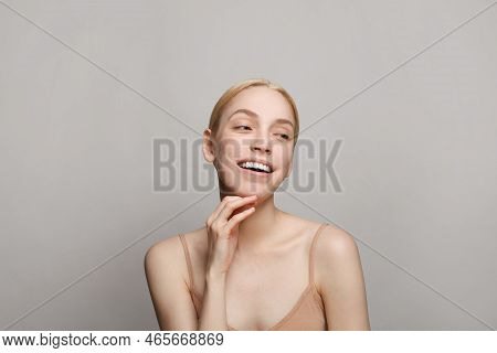 Beauty Portrait Of Attractive Blonde Woman With Natural Make-up On White Background. Facial Treatmen