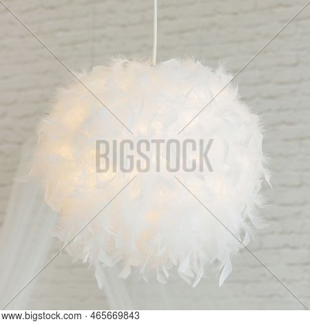 Modern Lamp With Abajur Made Of White Feathers, Gives Romantic Light In Bedroom