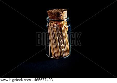 Bamboo Wooden Toothpicks In Glass Jar, Wine Glass. In Bucket. Toothpicks On Black Background. Front