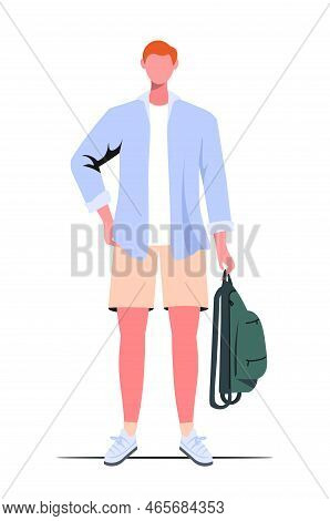 A Red Haired Young Guy In Casual Clothes Holds A Green Backpack On White Background.