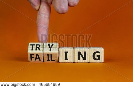 Failing Or Trying Symbol. Businessman Turns Wooden Cubes And Changes The Word 'failing' To 'trying'.