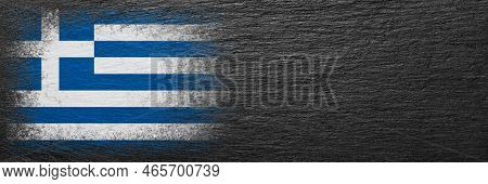 Flag Of Greece. Flag Is Painted On Black Slate Stone. Stone Background. Copy Space. Textured Creativ