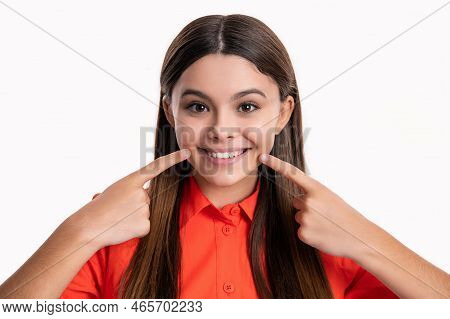 Tooth Of Teen Girl In Tshirt. Teen Girl Point Finger On Tooth. Teen Girl Showing Tooth In Studio.