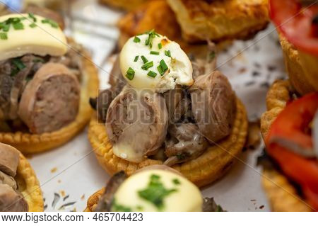 French Mini Quiche Pie With Goat Cheese And Traditional French Sausage Andouillette From Troyes In B