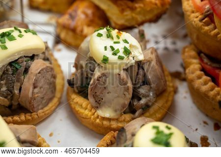 French Mini Quiche Pie With Goat Cheese And Traditional French Sausage Andouillette From Troyes In B