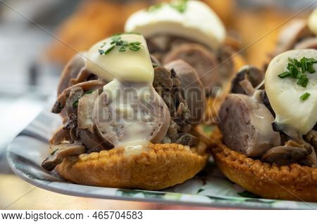 French Mini Quiche Pie With Goat Cheese And Traditional French Sausage Andouillette From Troyes In B