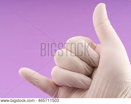 The Concept Of High And Success In Life. A Hand In Medical Gloves With A Certain Simple Sign. Lots O