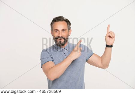 Portrait Of Positive Attractive Bearbed Grey-haired Man Promoter Point Index Finger Copyspace Indica