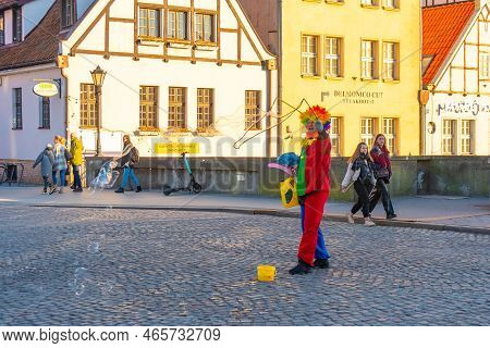 Gdansk, Poland - 11 March, 2022: A Man In Cloun Form Blows Soap Bubbles In Gdansk