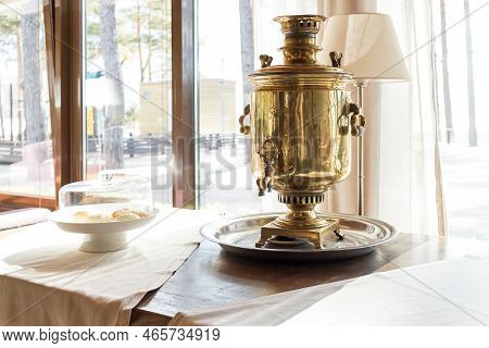 Traditional Russian Samovar On Table. Space For Text.metal Samovar On Grey Table In Kitchen. Russian