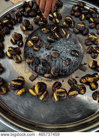 Fried Chestnuts On The Street. Street Food. Roasted Chestnuts