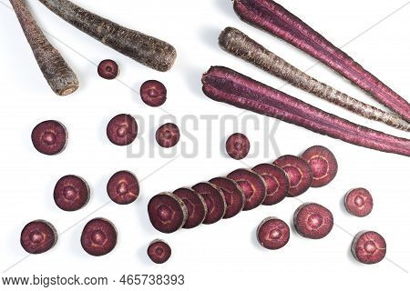 Unusual Root Vegetables. Purple Carrots On Light Background. Vegetables Whole And Chopped. Copy Spac