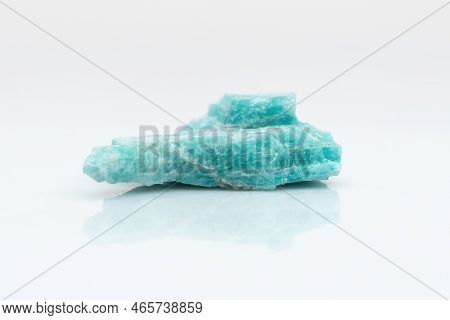 Natural Amazonite Gemstone Isolated On White Background. A Bluish-green Crystal On A White Backgroun