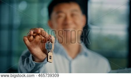 Successful Happy Asian Man Homeowner Businessman Realtor Estate Manager Hold Keys Of Modern Office B