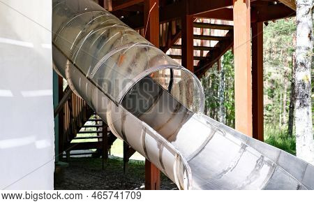 Childrens Slide In The Form Of A Pipe In An Amusement Park. Recreation And Entertainment Concept