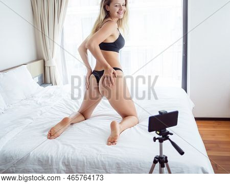 Young Sexy Woman Posing In Front Of Camera And Working As Webcam Model
