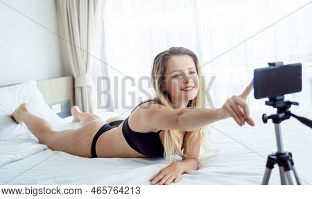 Young Sexy Woman Posing In Front Of Camera And Working As Webcam Model