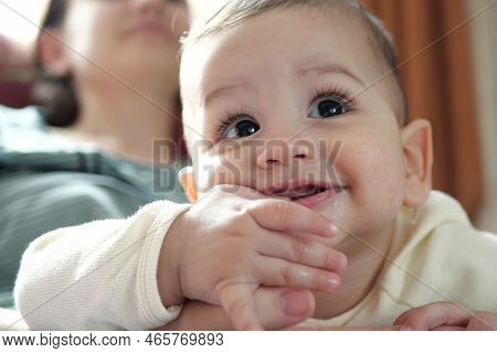 Cute Adorable Newborn Baby Playing With Colorful Rattle Toy. Baby With Teether. Six Months Old Lovel