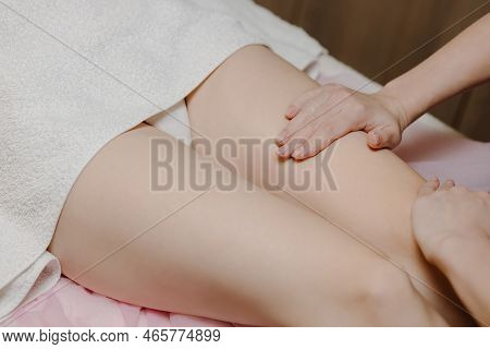 A Female Massage Therapist Gives An Anti-cellulite Massage To A Young Woman In A Spa Salon. Close-up