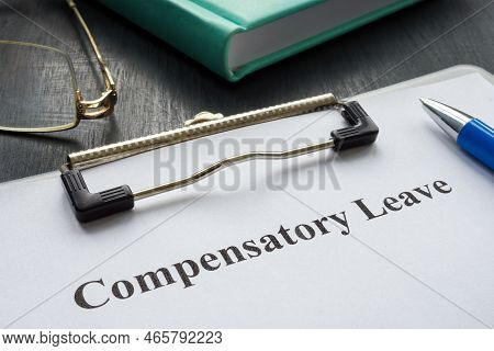 Document About Compensatory Leave And Pen For Signing.