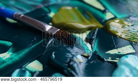 Brush On Artist's Palette With Mixed Paints, Closeup