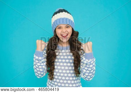 Happy Kid In Warm Sweater Selebrate Success. Keep Head In Warmth. Cozy And Comfortable.