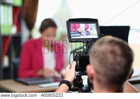 Close-up Of Camera On Tripod With Woman On Back Screen. Recording Video On Modern Camera. Personal V