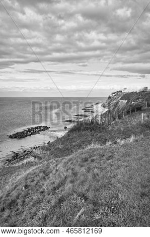 Hundested, Denmark On The Cliff Overlooking The Sea Taken In Black And White. Baltic Sea Coast, Gras