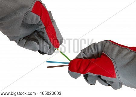Hands In Protective Gloves And Electric Cable Isolated On White Background. An Electrician Removes I