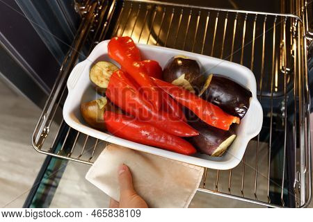 Red Peppers And Eggplant Roasting On Stove In Preparation For Making Ajvar, A Traditional Serbian Di