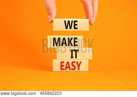 We Make It Easy Symbol. Concept Words We Make It Easy On Wooden Cubes. Beautiful Orange Table Orange