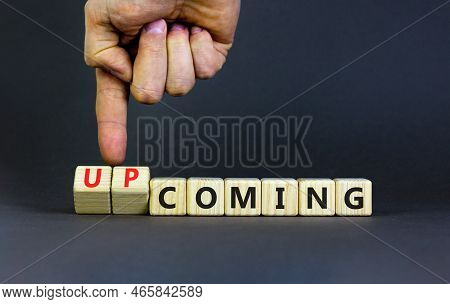 Coming Or Upcoming Symbol. Concept Words Coming And Upcoming On Wooden Cubes. Businessman Hand. Beau