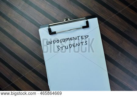 Concept Of Undocumented Students Write On Paperwork Isolated On Wooden Table.