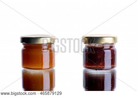 Jam In Many Jars On A White Isolated Background With Reflection. Orange Jelly Apricot Apple. Concept