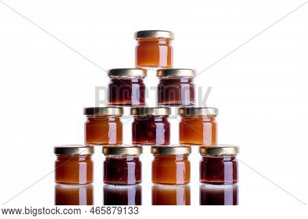Jam In Many Jars On A White Isolated Background With Reflection. Orange Jelly Apricot Apple. Concept
