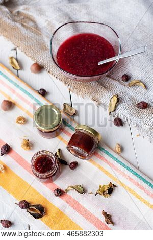 Jam In A Jar And A Spoon. Apple And Pear Jam In A Spoon On A White Mirror Background. Healthy Natura