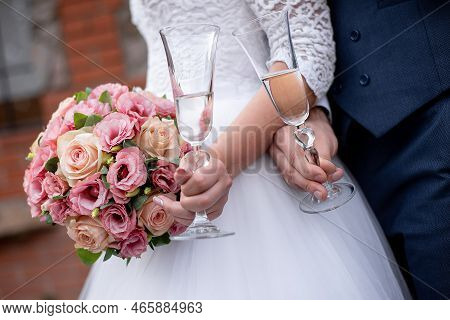 Bride\\\'s Hands On The Groom\\\'s Boutonniere. Wedding Decor For The Wedding Ceremony Of Flowers Fo