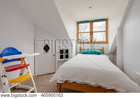 Toft, Cambridgeshire, England - March 4 2019: Attic Childs Bedroom With Eaves Playhouse Style Wardro