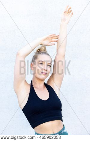 Beautiful Young Blonde Fitness Woman Wearing Blaack And Blue Sports Clothes Stretching And Full Body