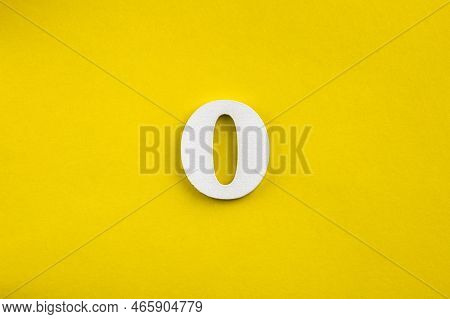 Number Zero - White Number In Wood On Yellow Background