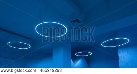 Ceiling With Round Modern Led Lamps. Suspended Fluorescent Lights Under The Ceiling. Careful Energy 