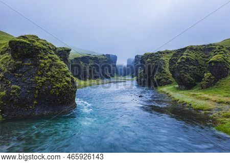 The Famous And Unique Fjadrargljufur Valley In Iceland On A Rainy Day. Mossy Cliffs And Mountain Riv