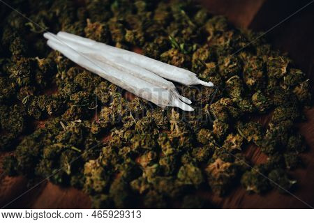 Joints Are On The Table. Three Crossed Joints In Marijuana Buds, Indica Sativa сbd Medicinal.